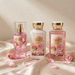 Rose body mist, body lotion, and shower gel arranged on satin with pink roses and petals