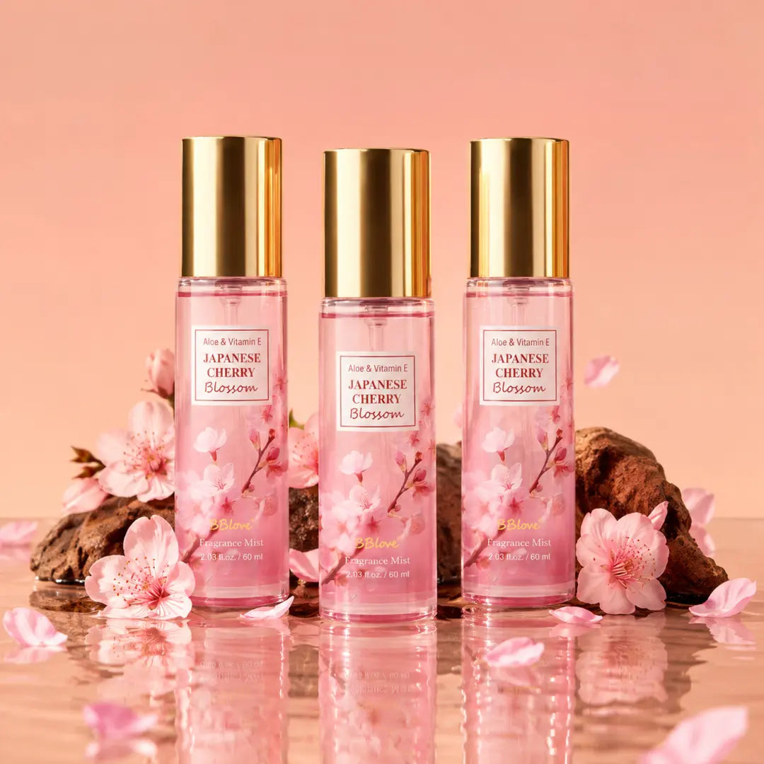 Japanese Cherry Blossom Body Mist 3-piece set with pink fragrance mist bottles, cherry blossoms, petals, and glossy reflection