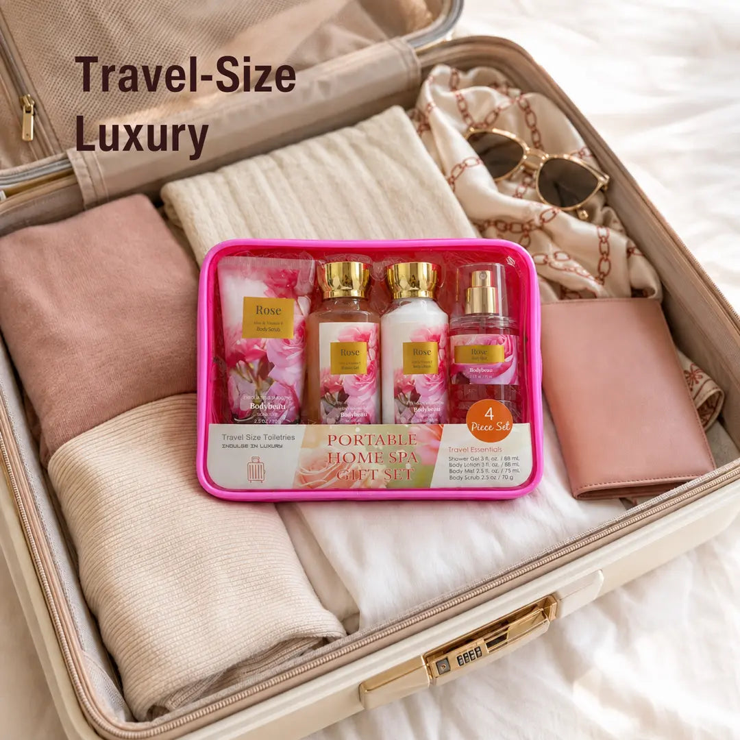 Travel-size Rose four-piece bath set in a reusable cosmetic pouch inside an open suitcase